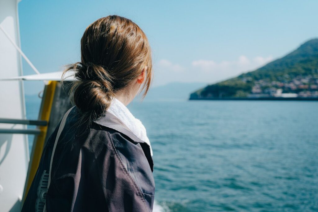 Woman looking out at the ocean from a boat.