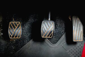 Three car pedals on the floor
